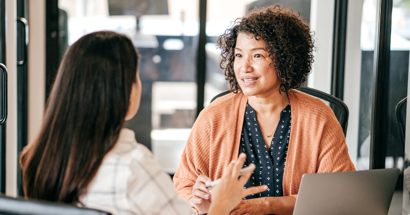 Female employees discussing work.