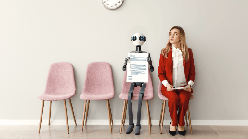 Lady in a red suit with a resume sits next to a robot with a resume
