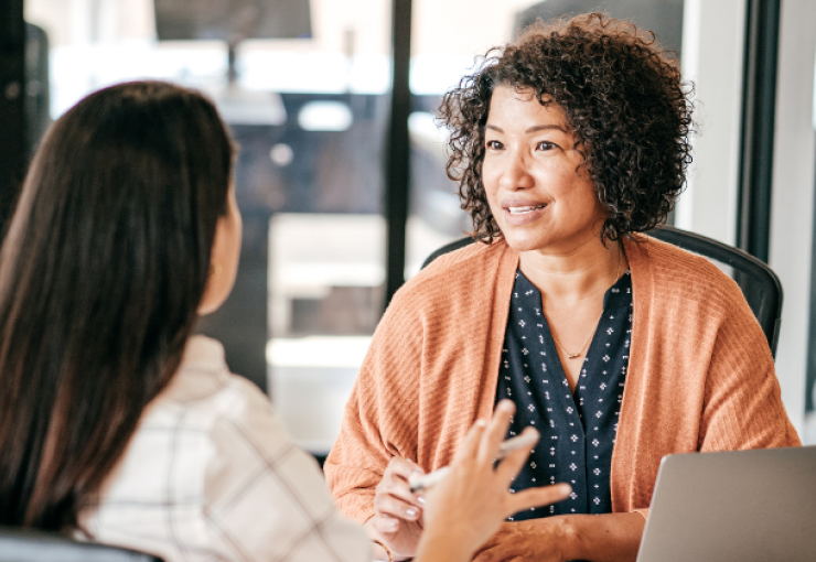 Female employees discussing work.